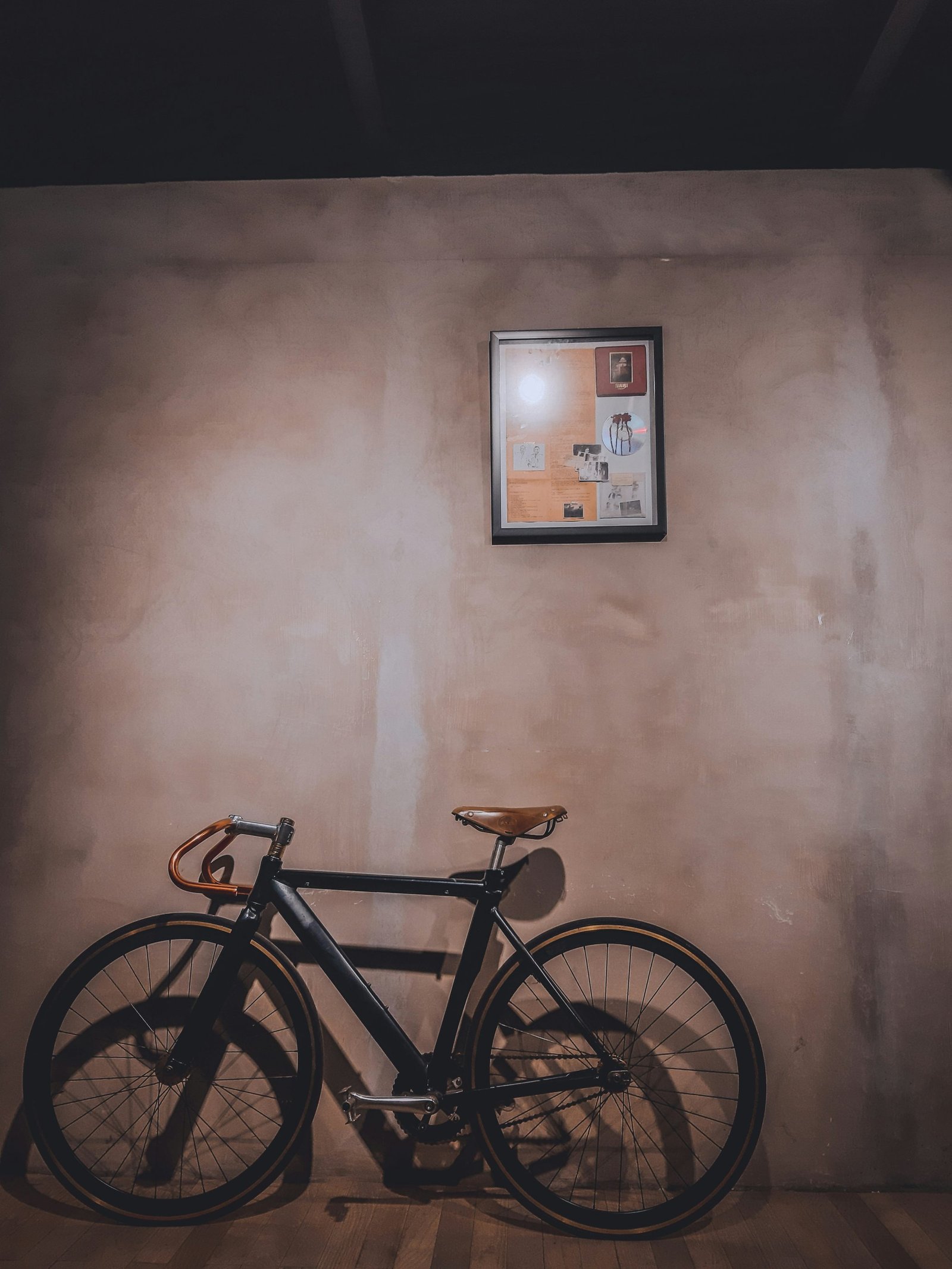 Bicycle leaning against a wall in a city street