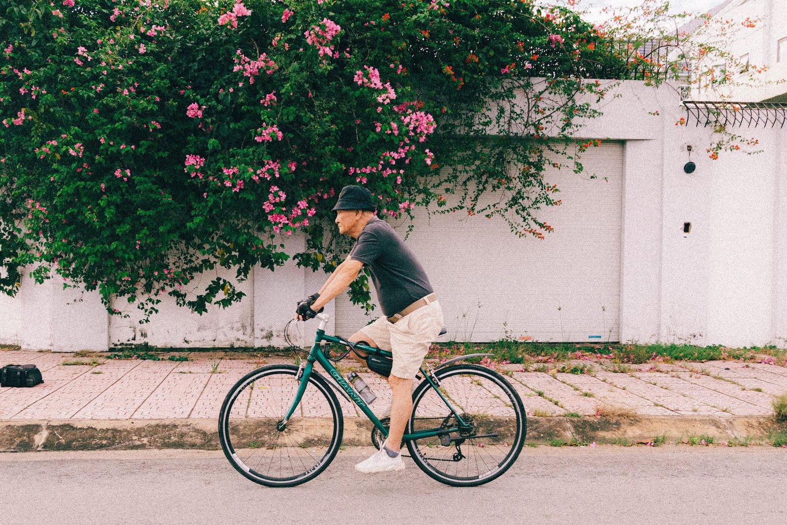 Rider cycling down a quiet residential street