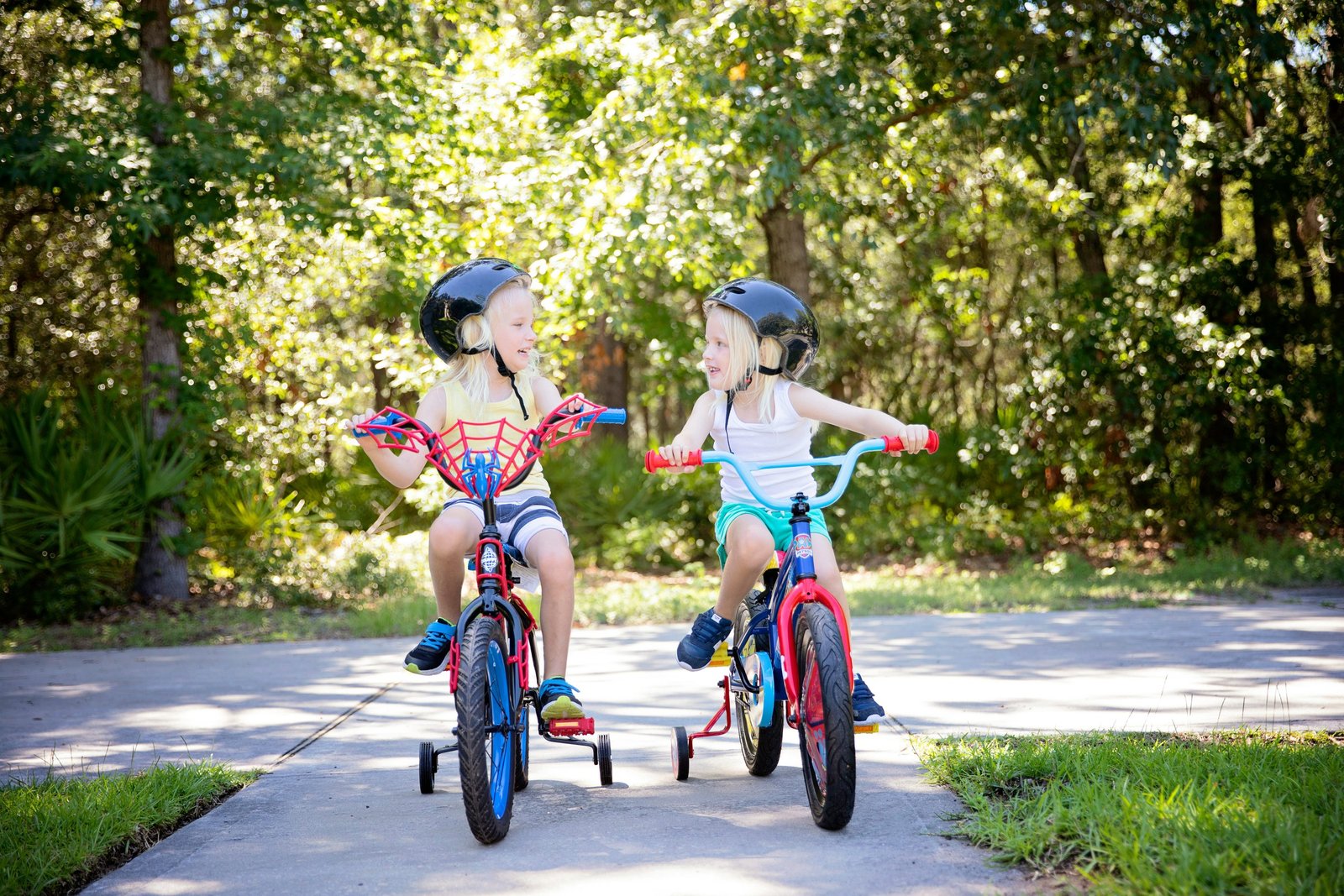 Two children cycling on a park path