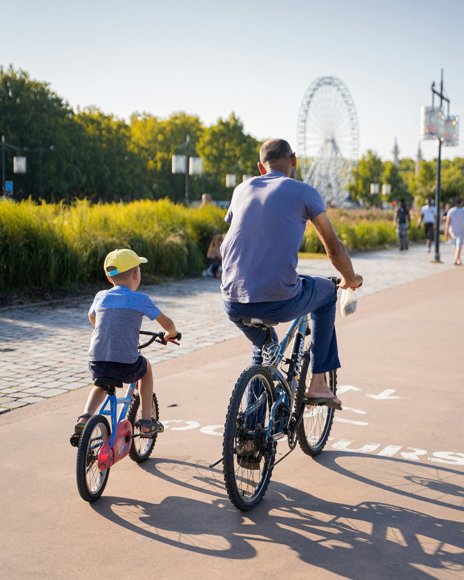 Parent and child cycling on a scenic path