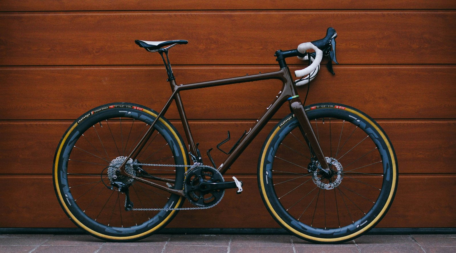 Road bike leaning on a wooden wall